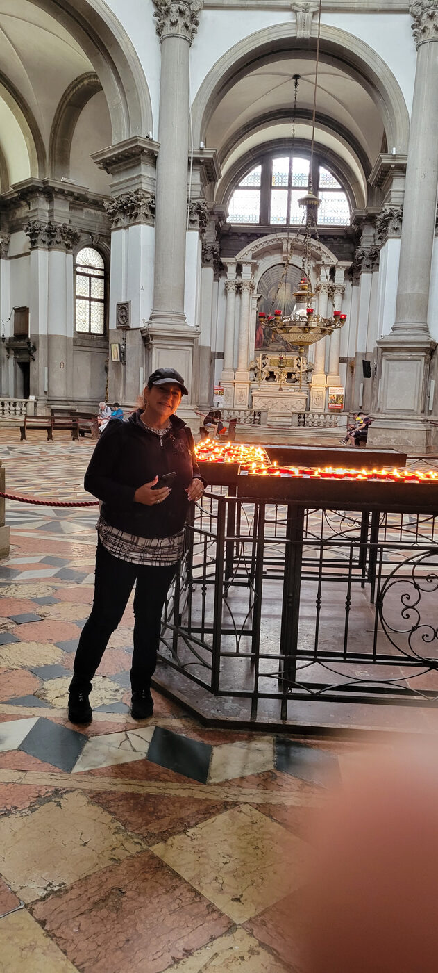 Bea Hernandez inside a Venetian basilica with candles